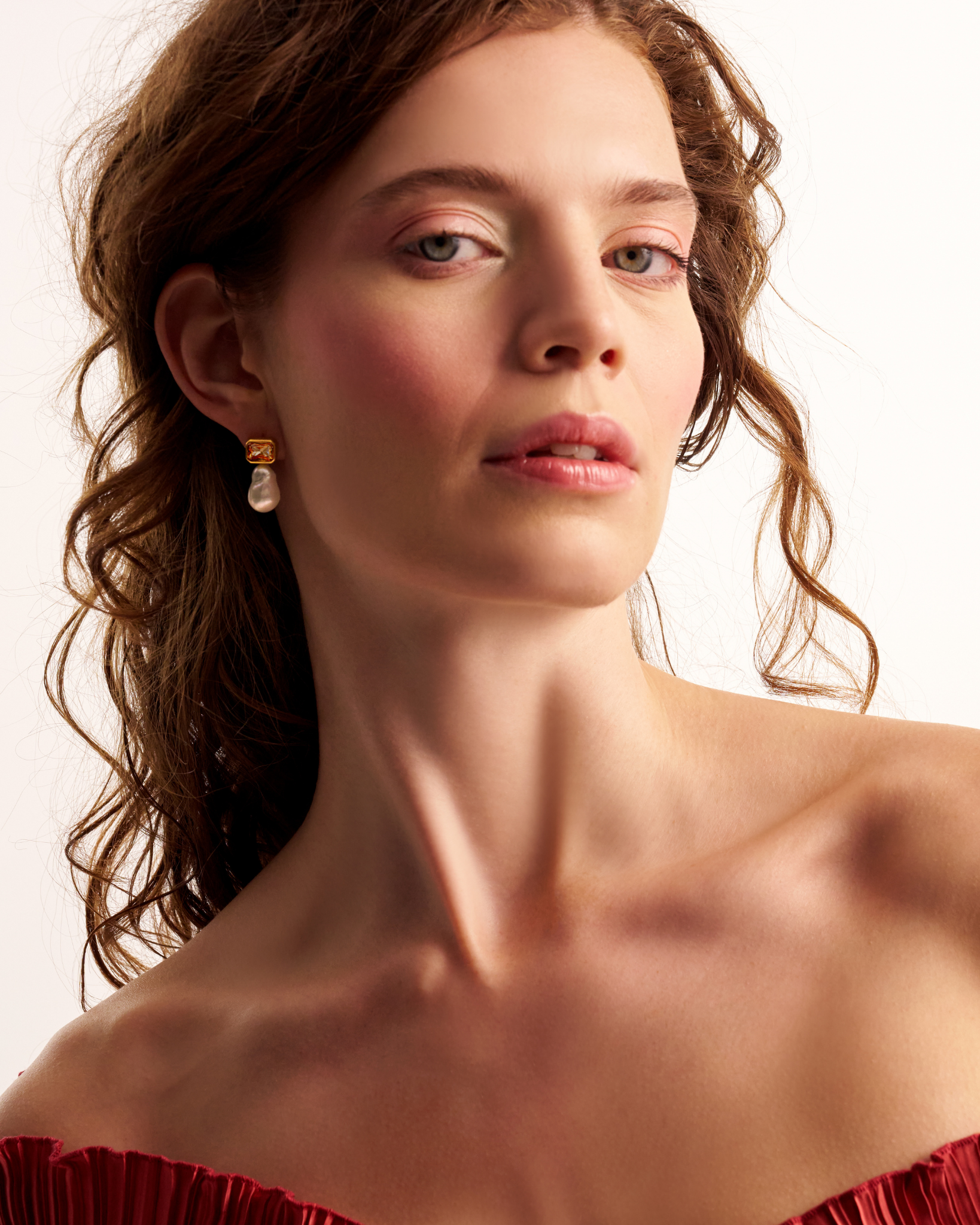 Woman wearing elegant pearl drop earrings