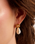 Close-up of woman wearing pearl drop earrings