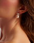 Close-up of woman wearing pearl drop earrings