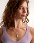 Woman styling minimalist pearl necklace