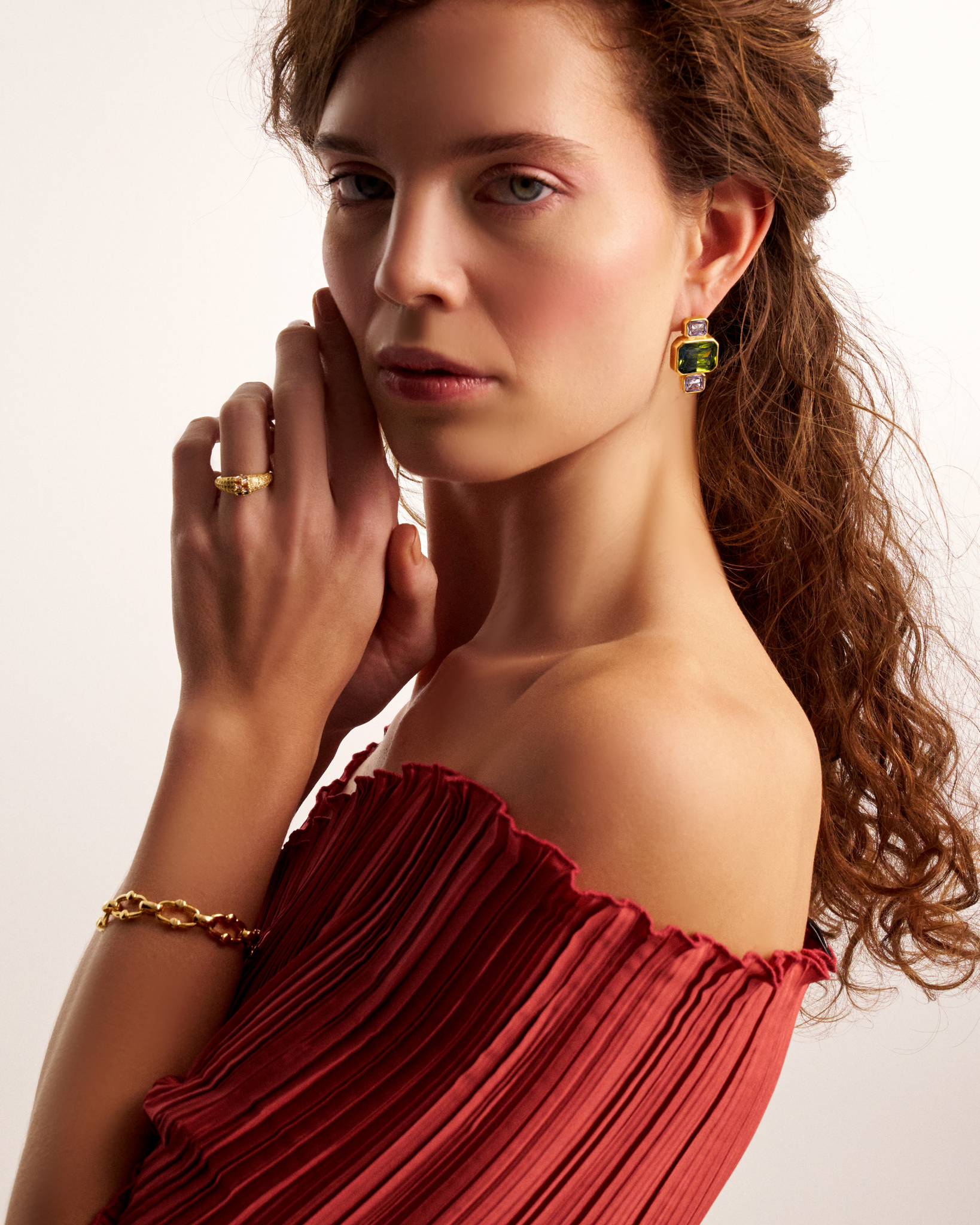 Woman wearing gold stardust ring with multicolor gemstones