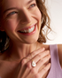 Smiling woman wearing pearl pendant necklace