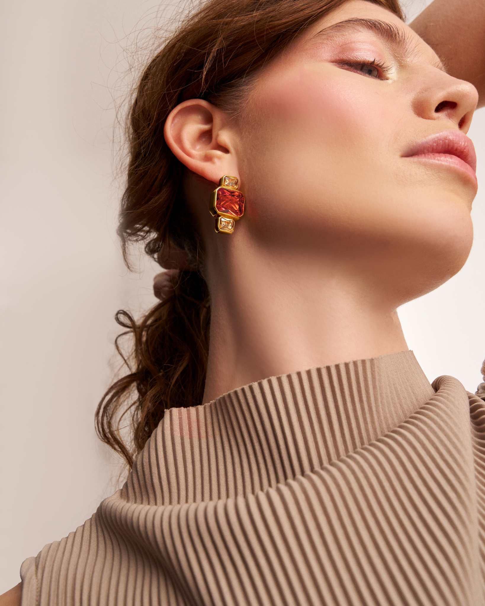Woman wearing modern gold statement earrings