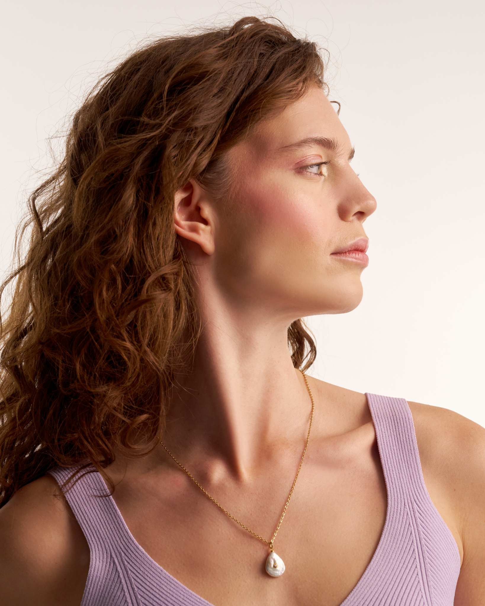 Close-up of gold necklace with freshwater pearl