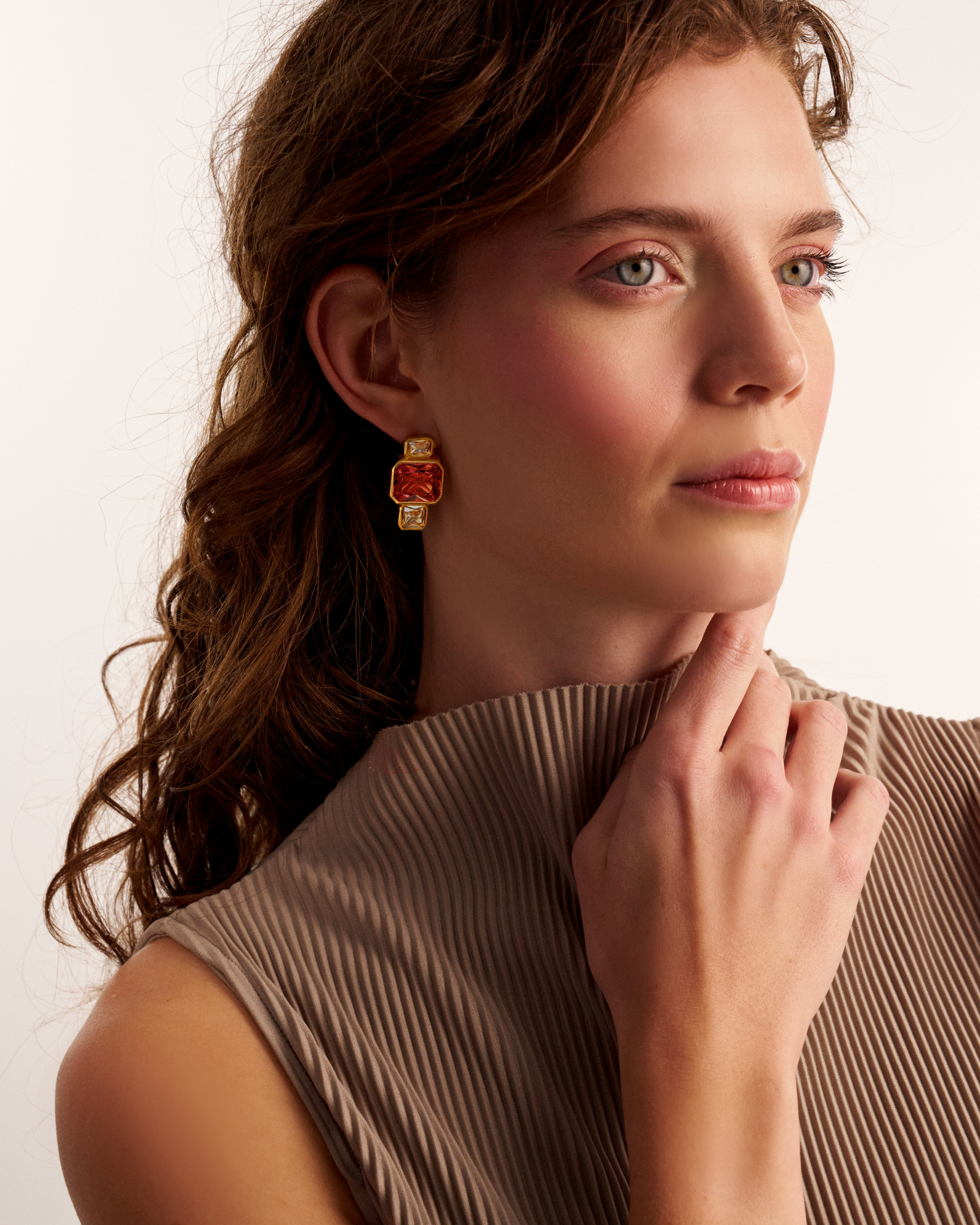Woman wearing modern gold statement earrings