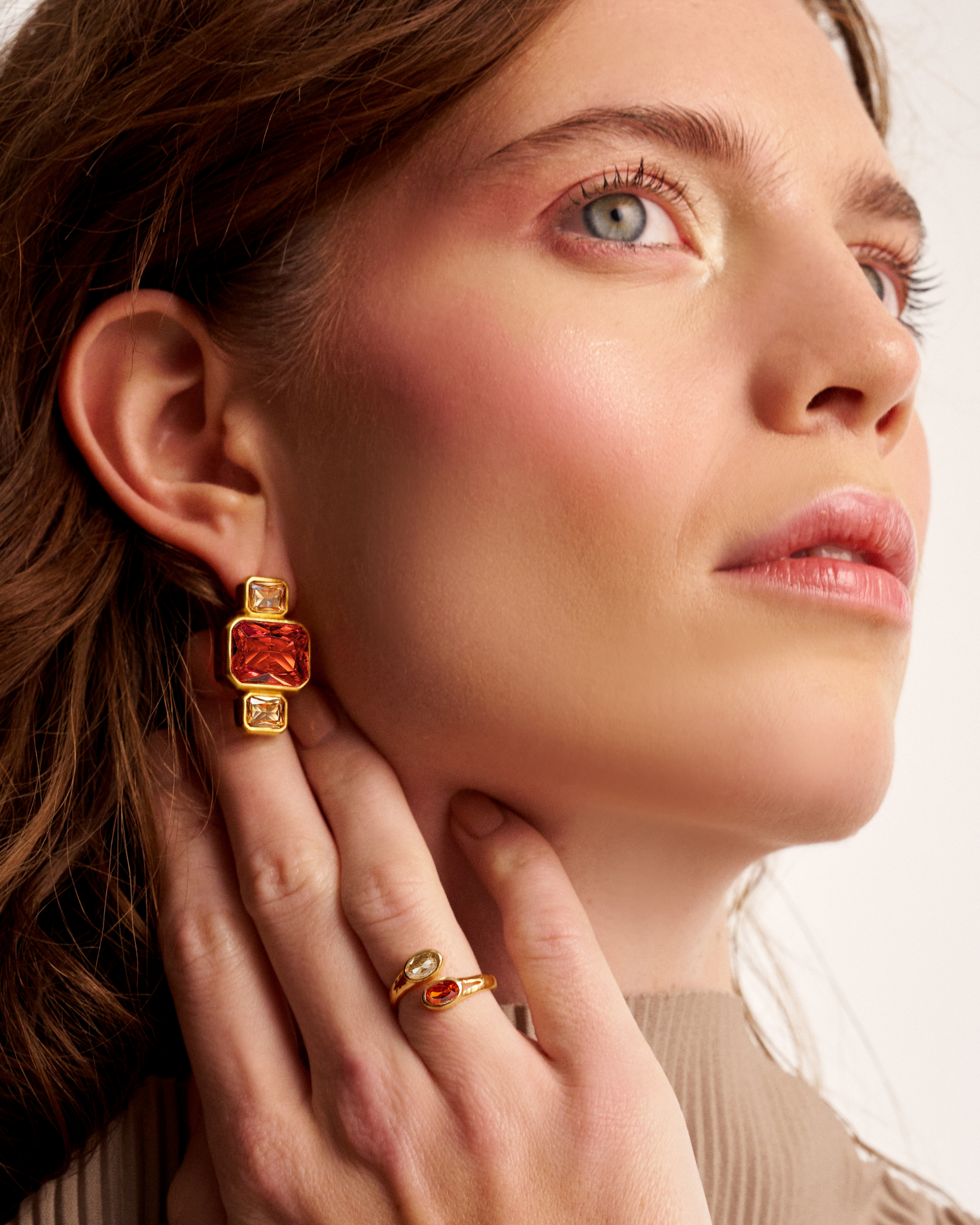 Woman wearing sculptural gold earrings