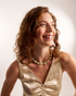 Smiling woman styling green beaded necklace