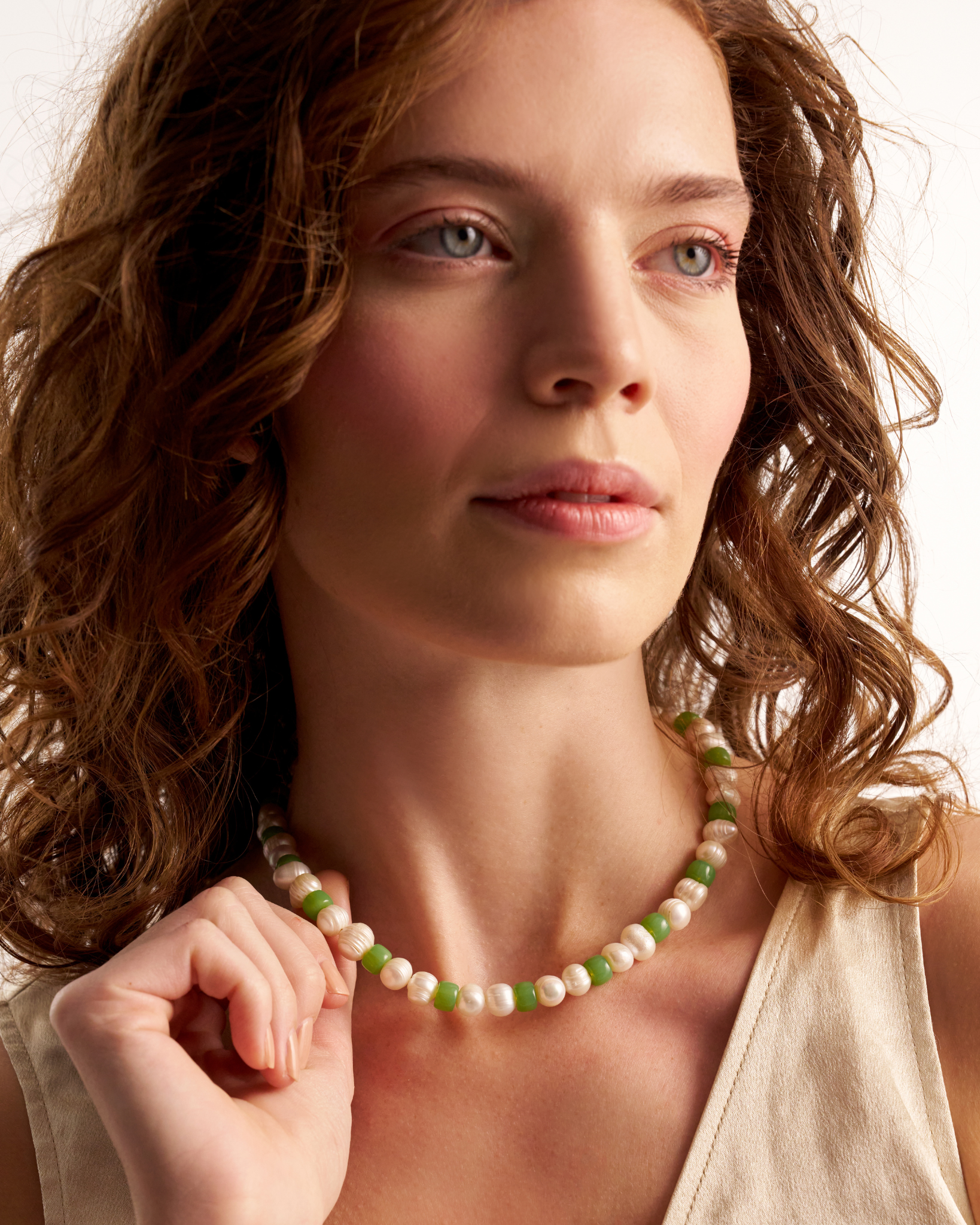 Woman wearing green pearl necklace