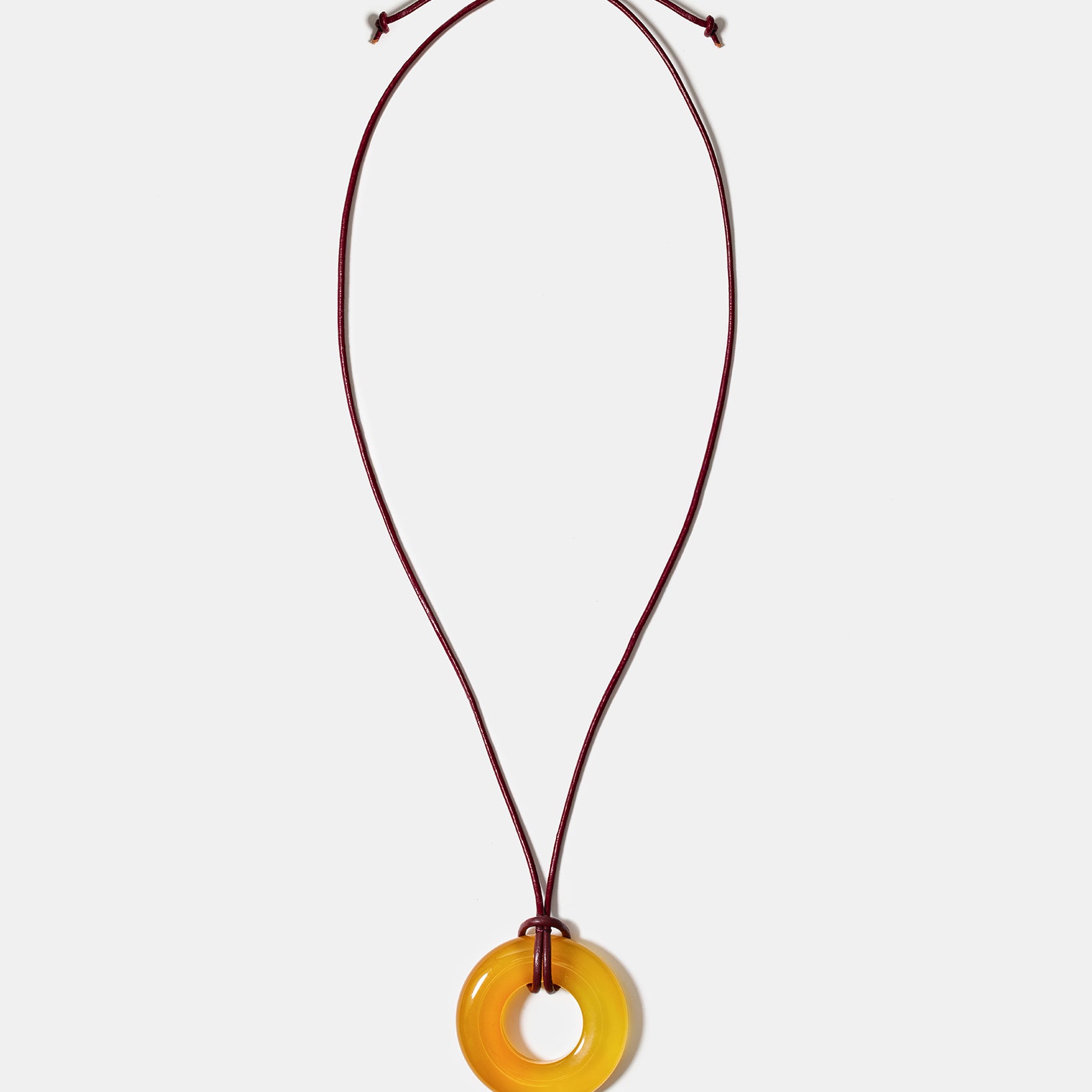 Golden agate donut pendant necklace on adjustable burgundy cord
