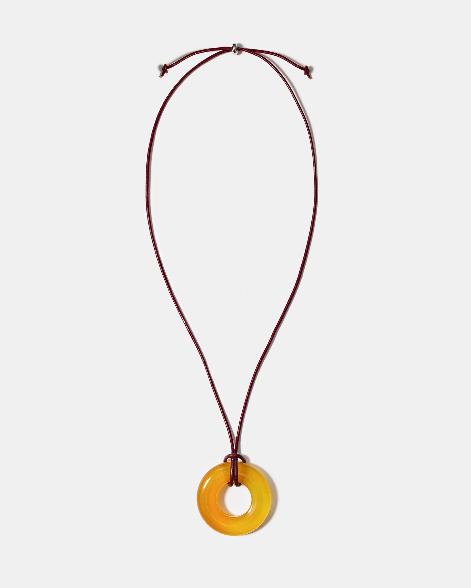 Golden agate donut pendant necklace on adjustable burgundy cord