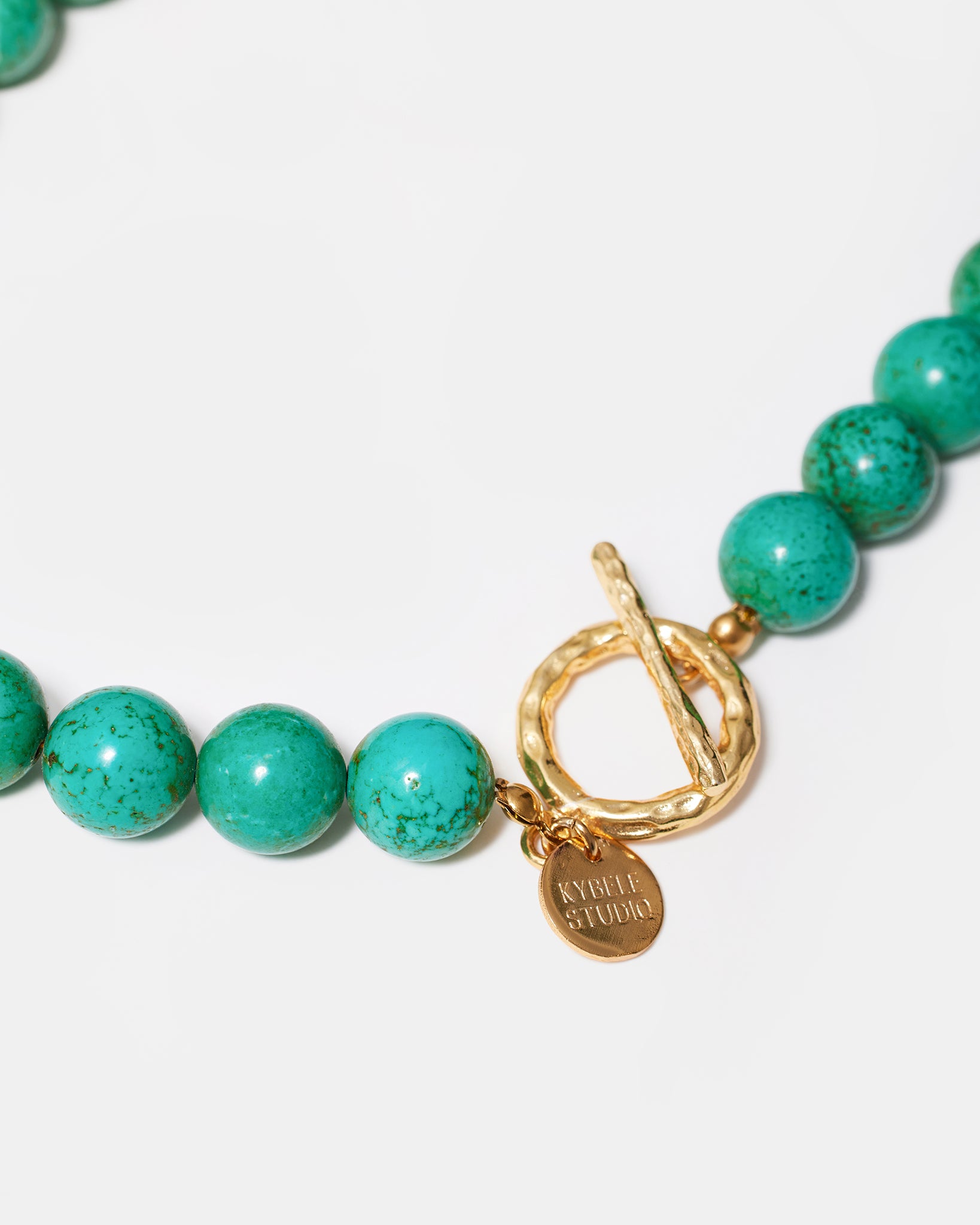Turquoise gemstone necklace with gold-tone clasp detail