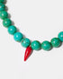 Close-up of turquoise bead necklace and red glass chili pendant