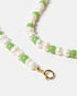 Close-up of green beaded pearl necklace
