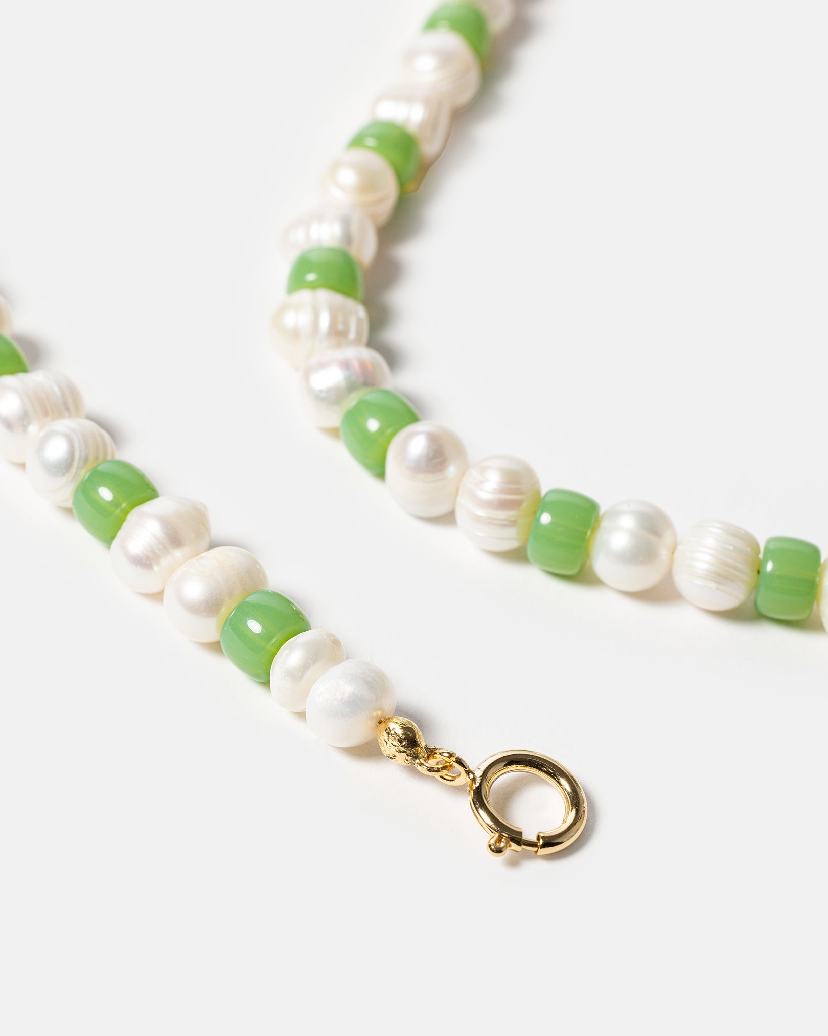 Close-up of green beaded pearl necklace