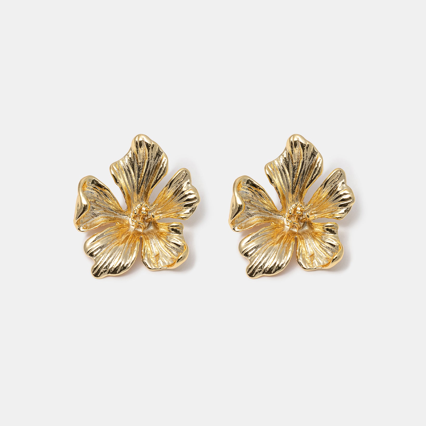 Textured flower stud earrings close-up