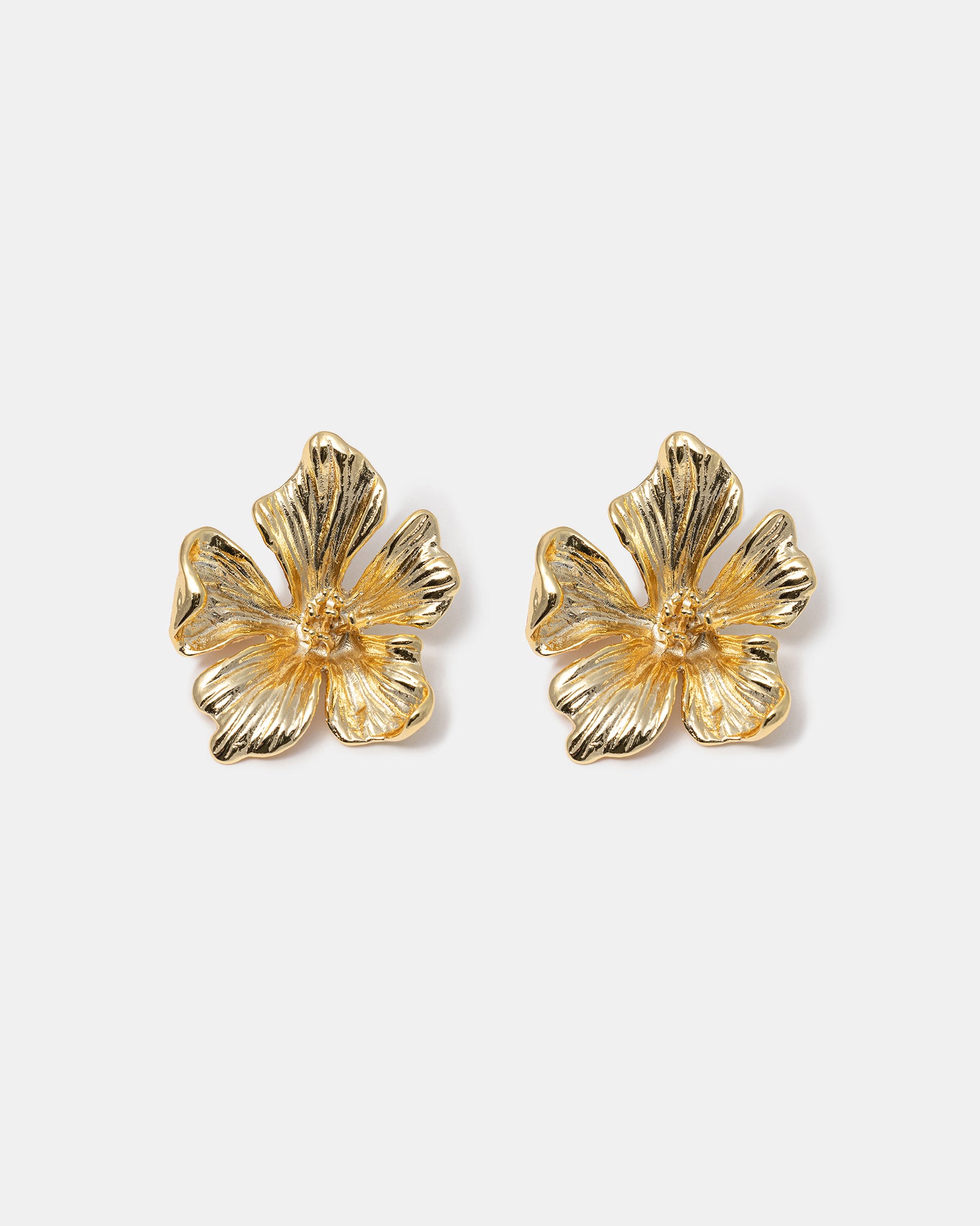 Textured flower stud earrings close-up