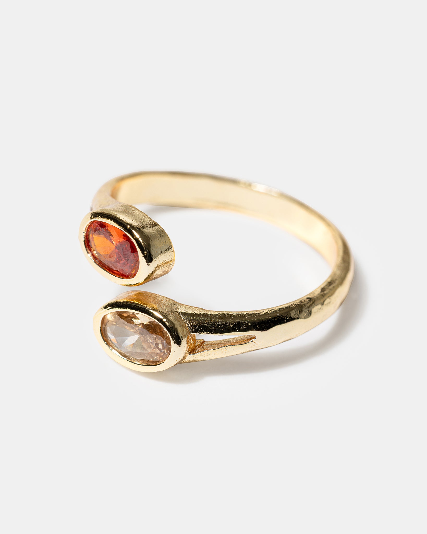 Side view of gold open ring with oval gemstones