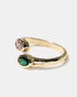 Side view of gold open ring with pink and green gemstones