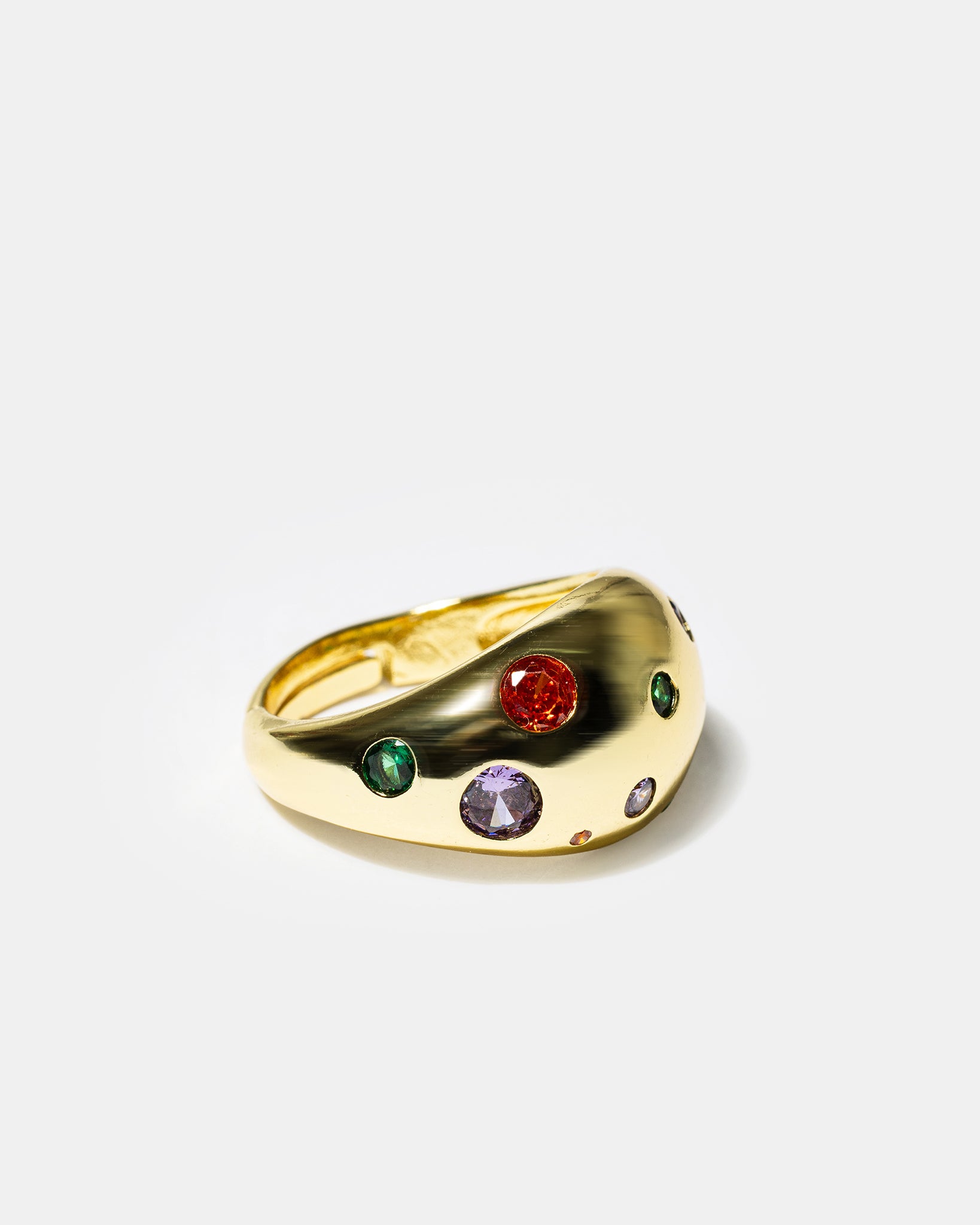 Side view of gold dome cocktail ring with multicolor gemstones