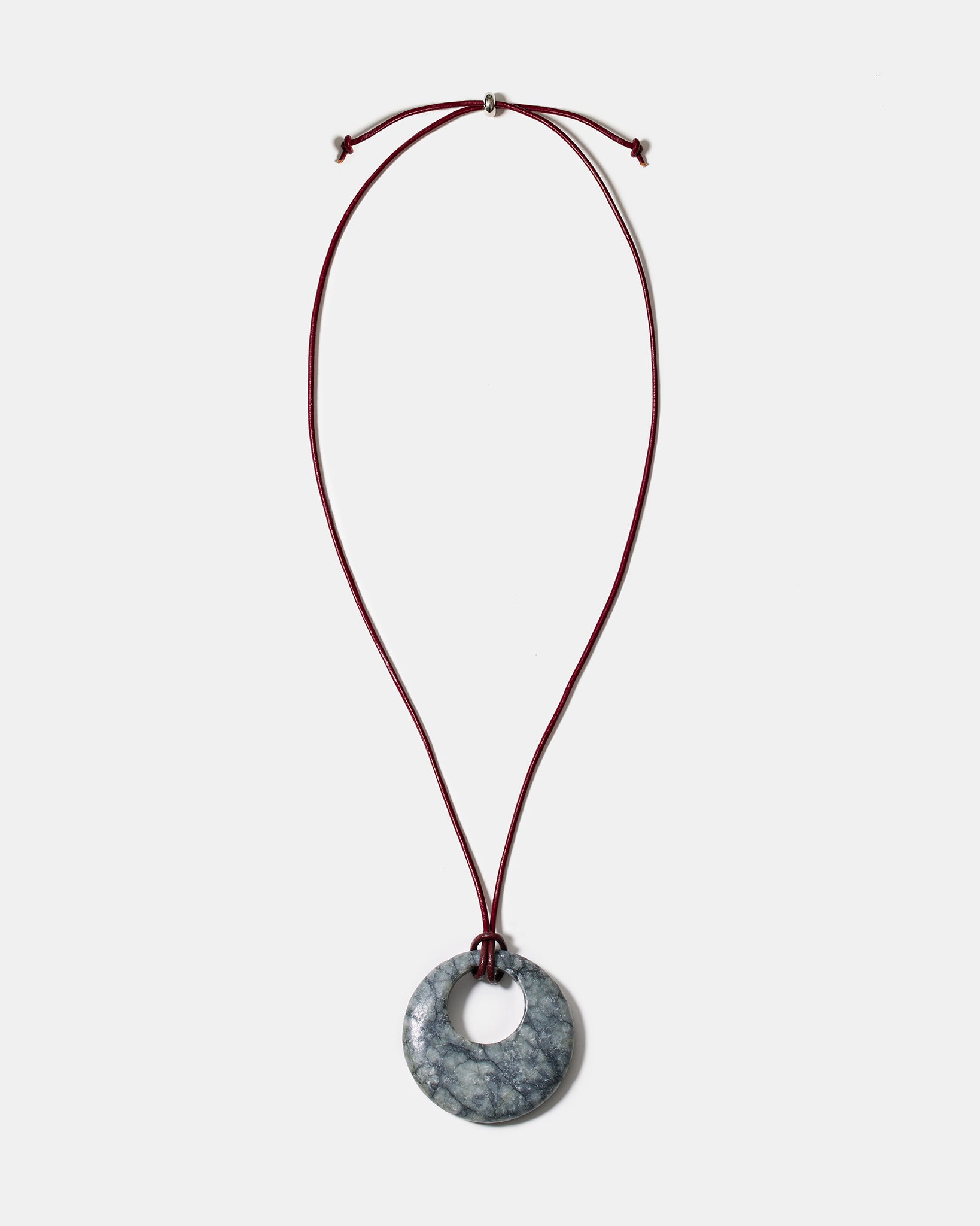 Black rhodonite donut pendant necklace on adjustable burgundy cord