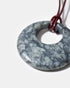 Close-up of black rhodonite gemstone pendant with organic stone patterns