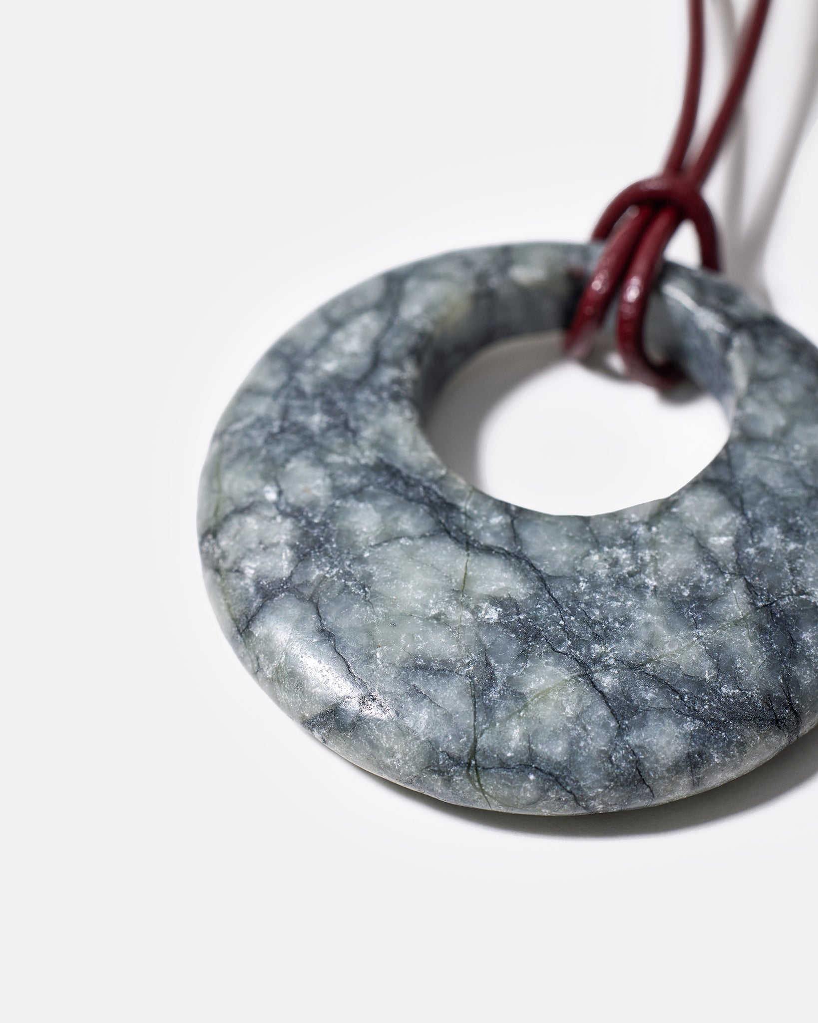 Close-up of black rhodonite gemstone pendant with organic stone patterns