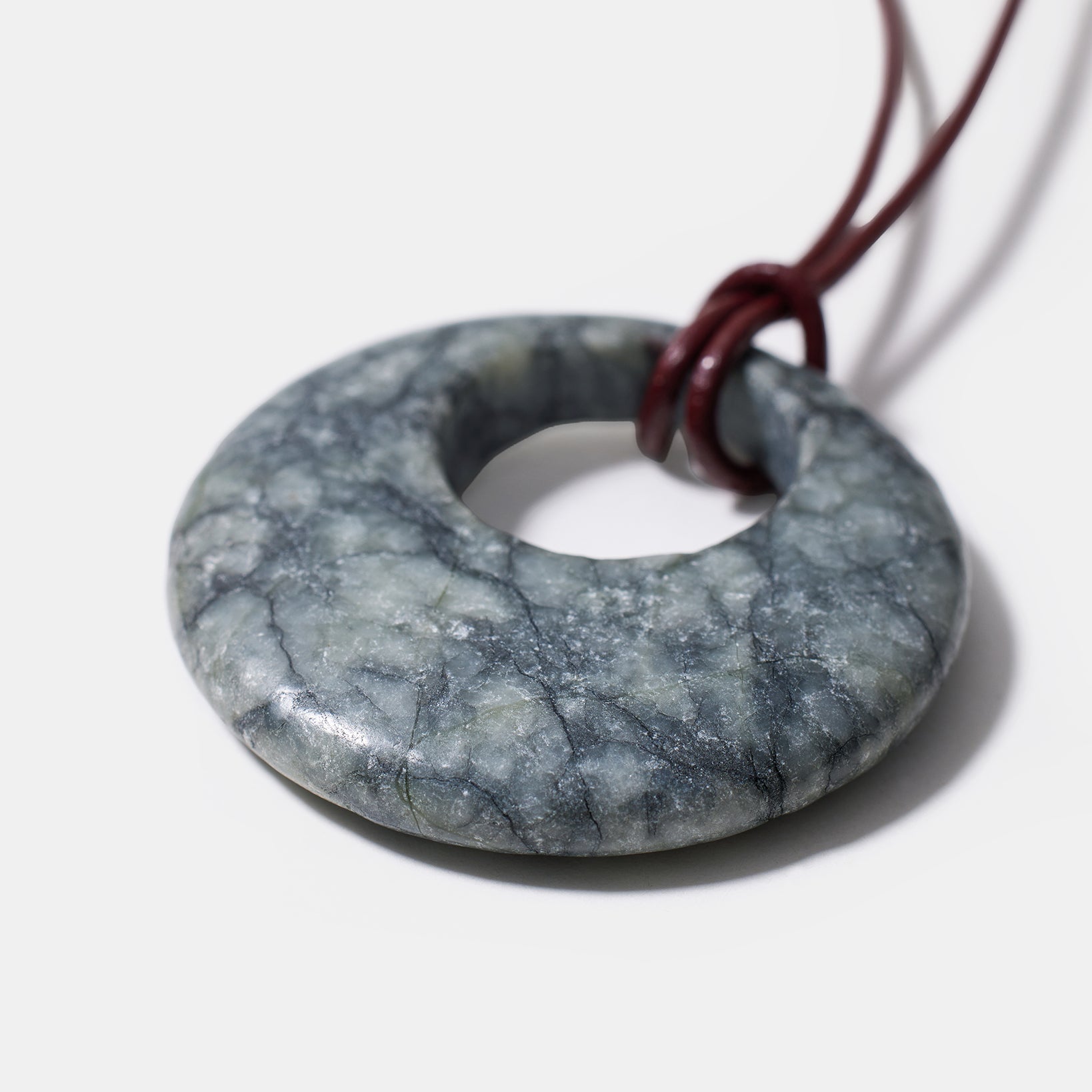 Black rhodonite donut pendant necklace with natural marbled gemstone