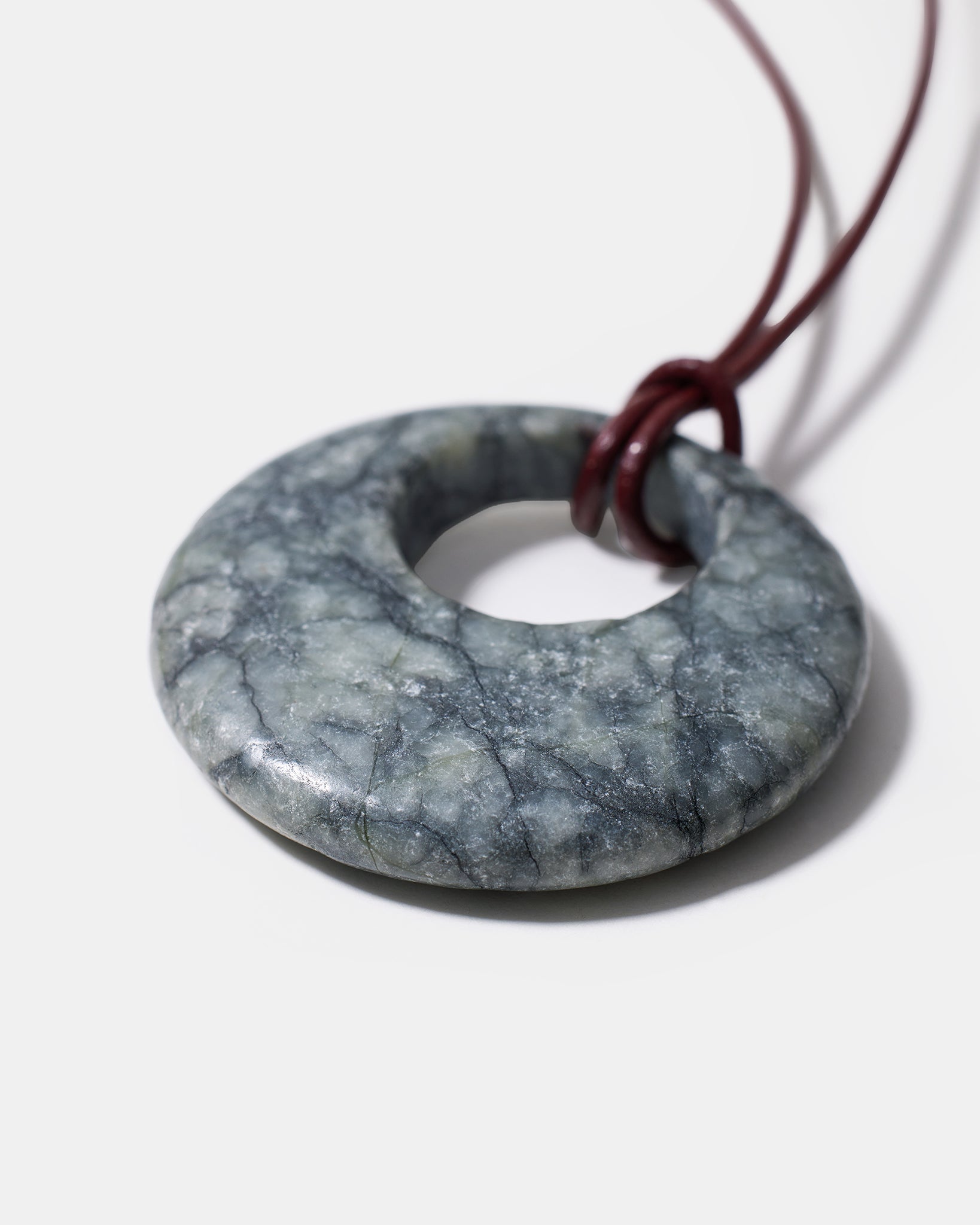 Black rhodonite donut pendant necklace with natural marbled gemstone