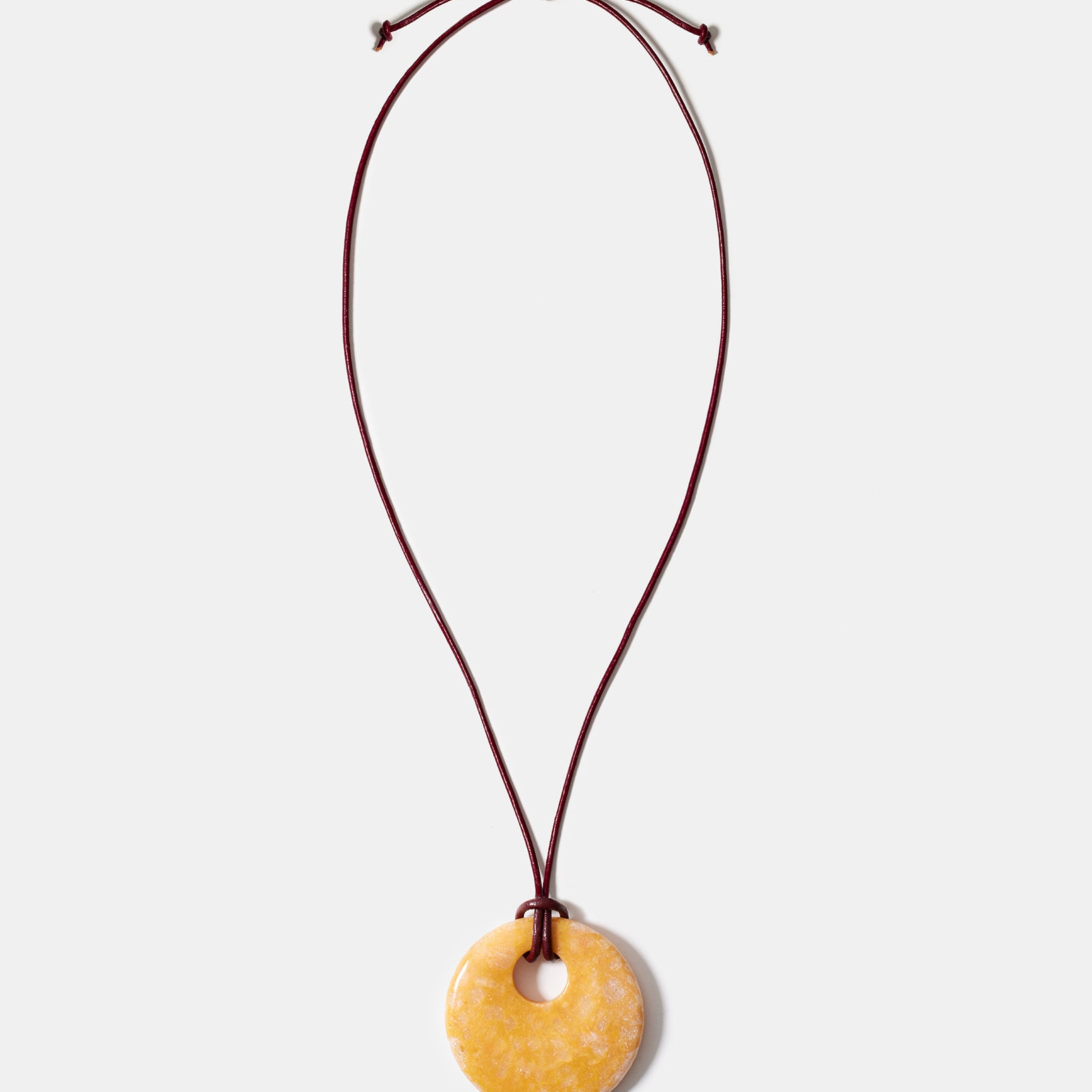 Yellow calcite donut pendant necklace on adjustable burgundy cord