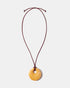 Yellow calcite donut pendant necklace on adjustable burgundy cord