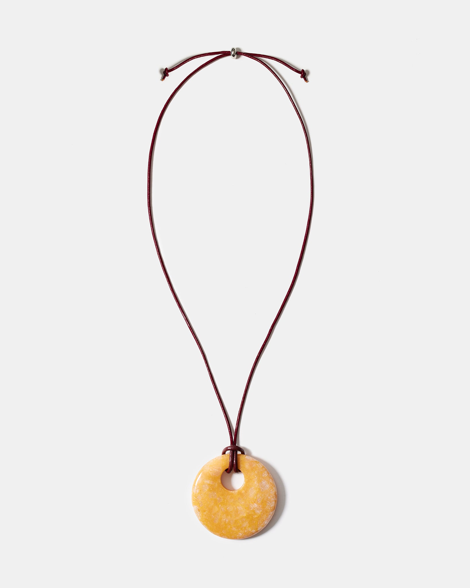 Yellow calcite donut pendant necklace on adjustable burgundy cord