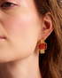 Close-up of gold geometric gemstone earrings