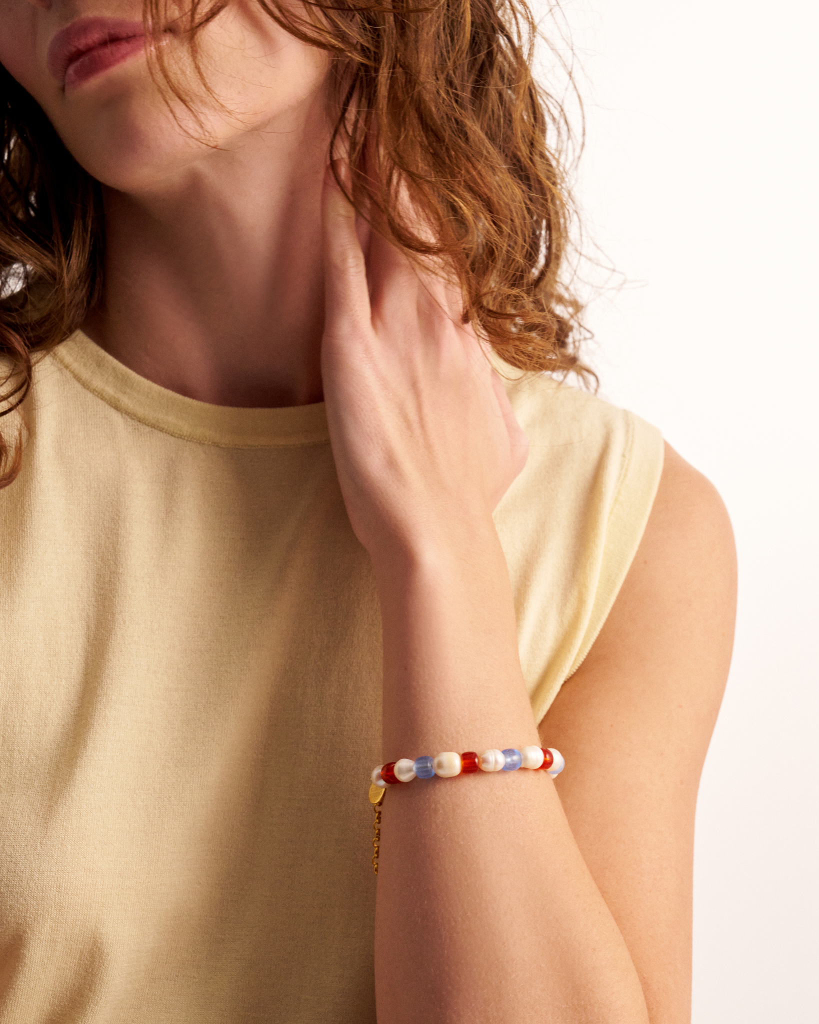 Woman styling colorful beaded bracelet