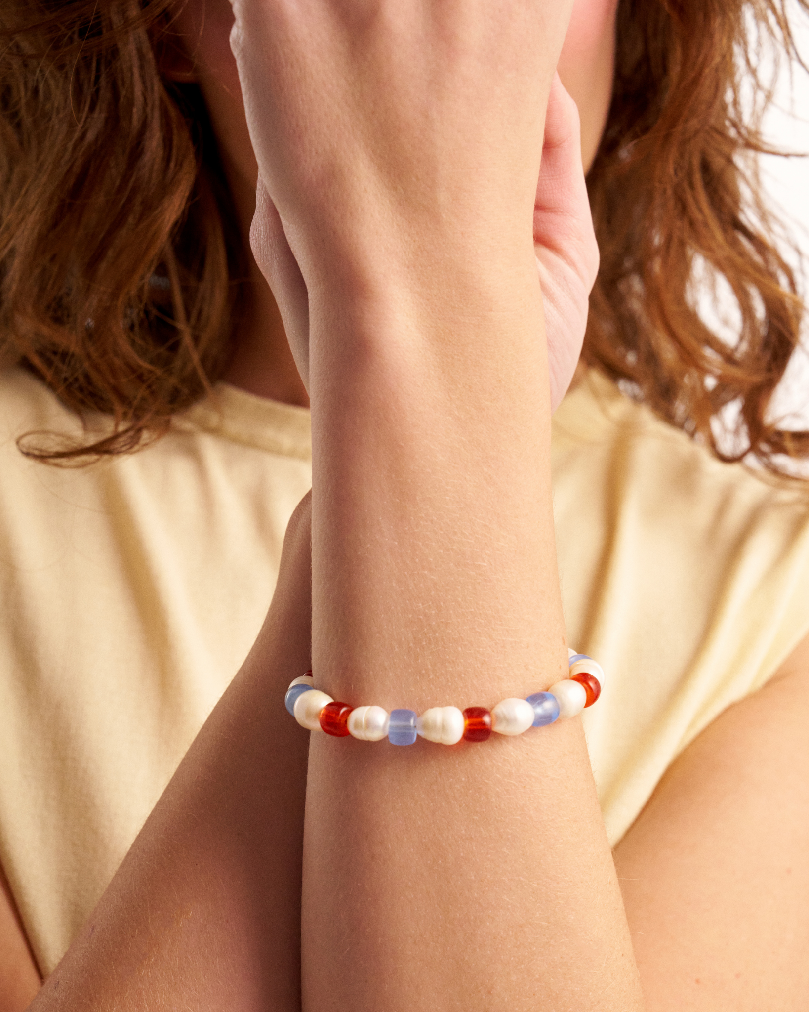 Close-up of pastel pearl and glass bead bracelet
