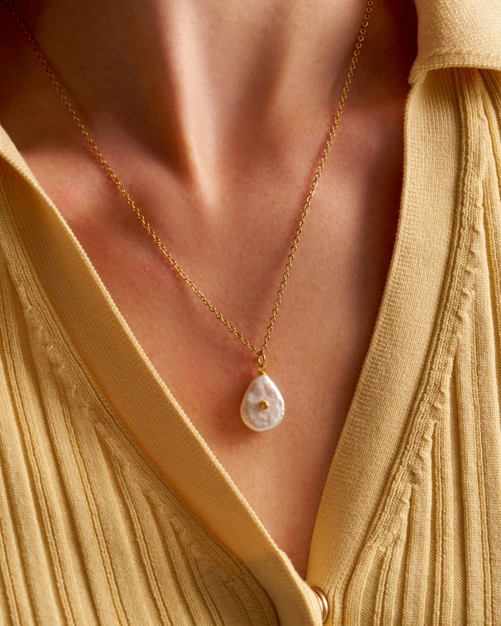 Woman wearing delicate pearl necklace