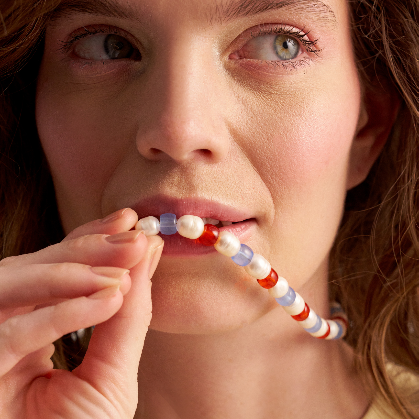 Woman wearing colorful pearl necklace