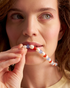 Woman wearing colorful pearl necklace