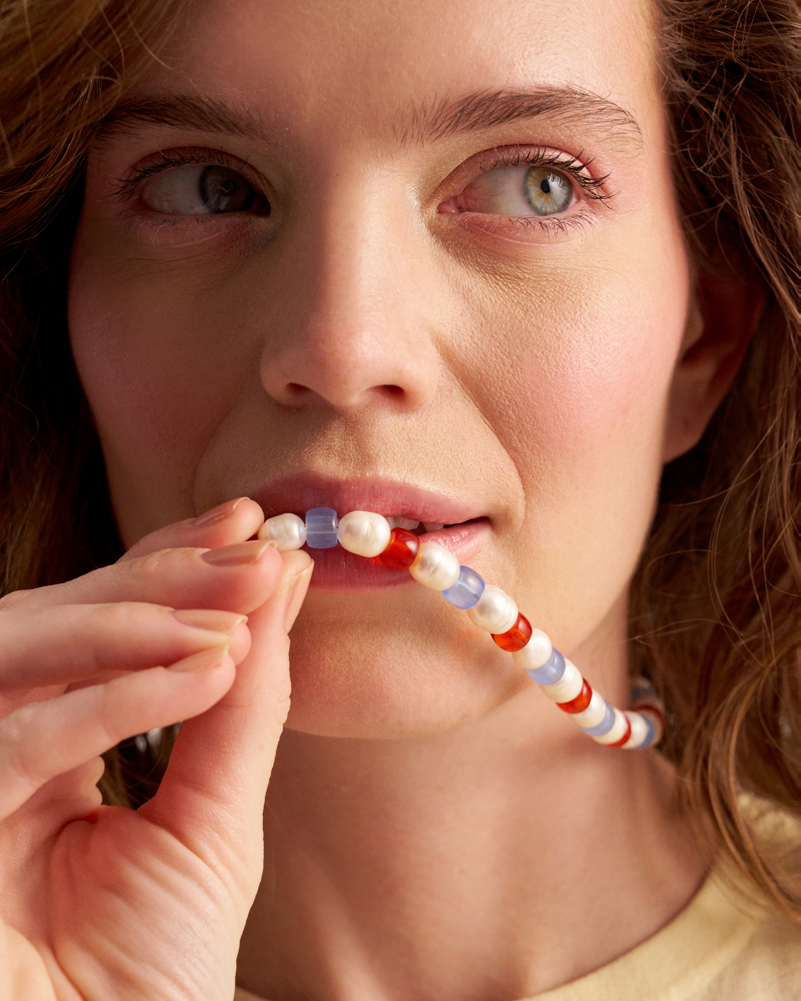 Woman wearing colorful pearl necklace