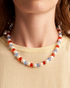 Close-up of beaded pearl necklace on neck