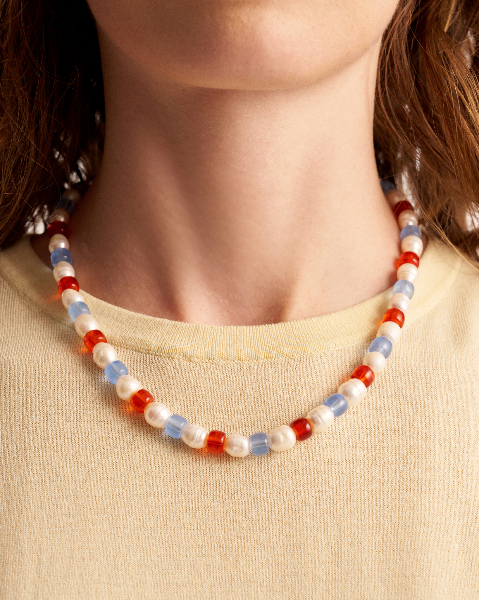 Close-up of beaded pearl necklace on neck