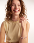 Woman wearing colorful pearl bracelet