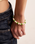 Close-up of green pearl bracelet on wrist