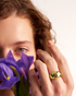Close-up of gold dome cocktail ring with purple iris flowers