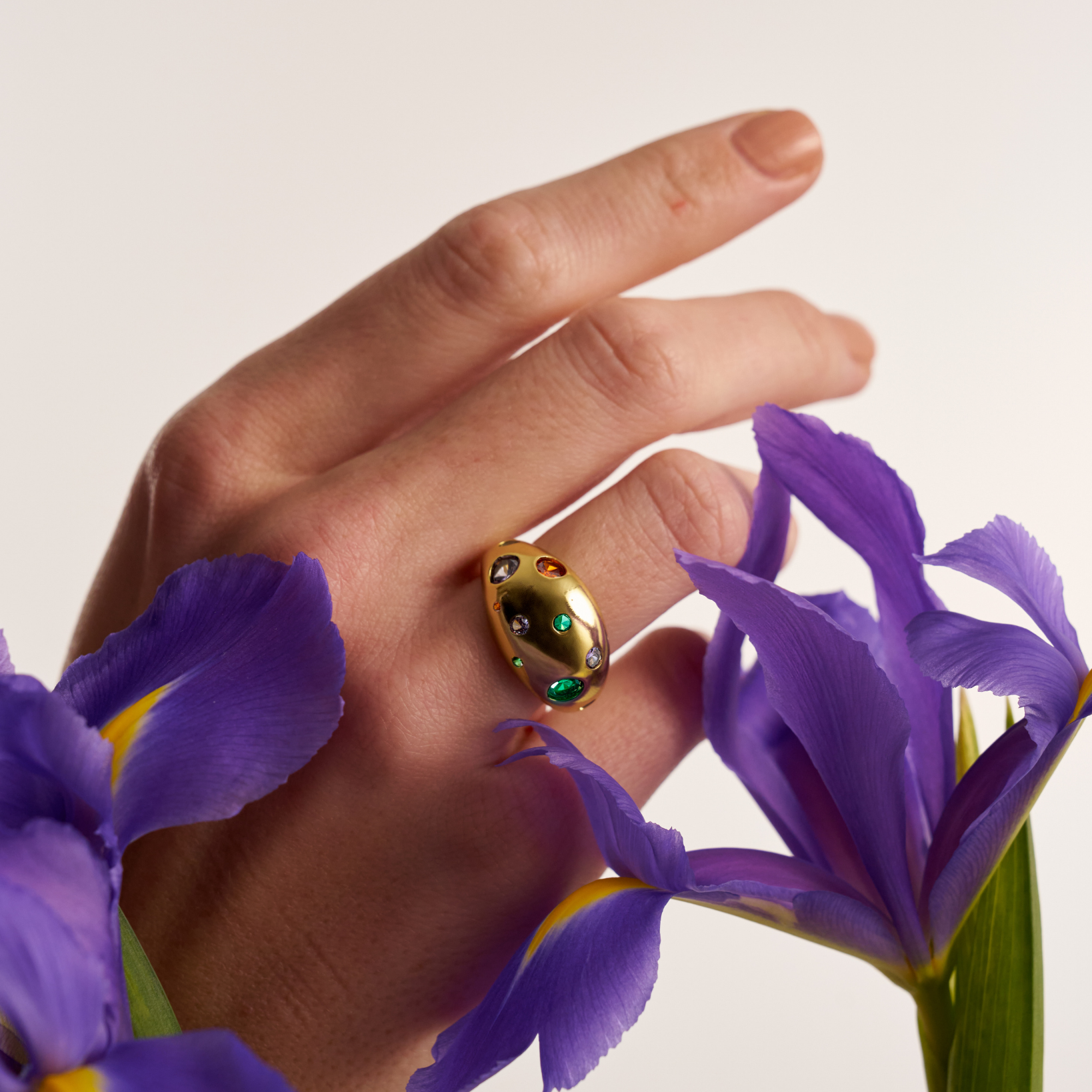 Gold dome cocktail ring with multicolor gemstones and purple iris flowers