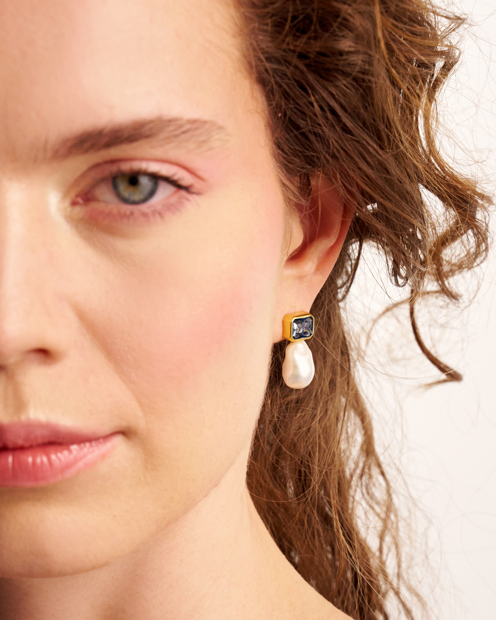 Close-up portrait with gold pearl earrings
