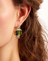 Close-up of gold geometric stud earrings with green gemstones